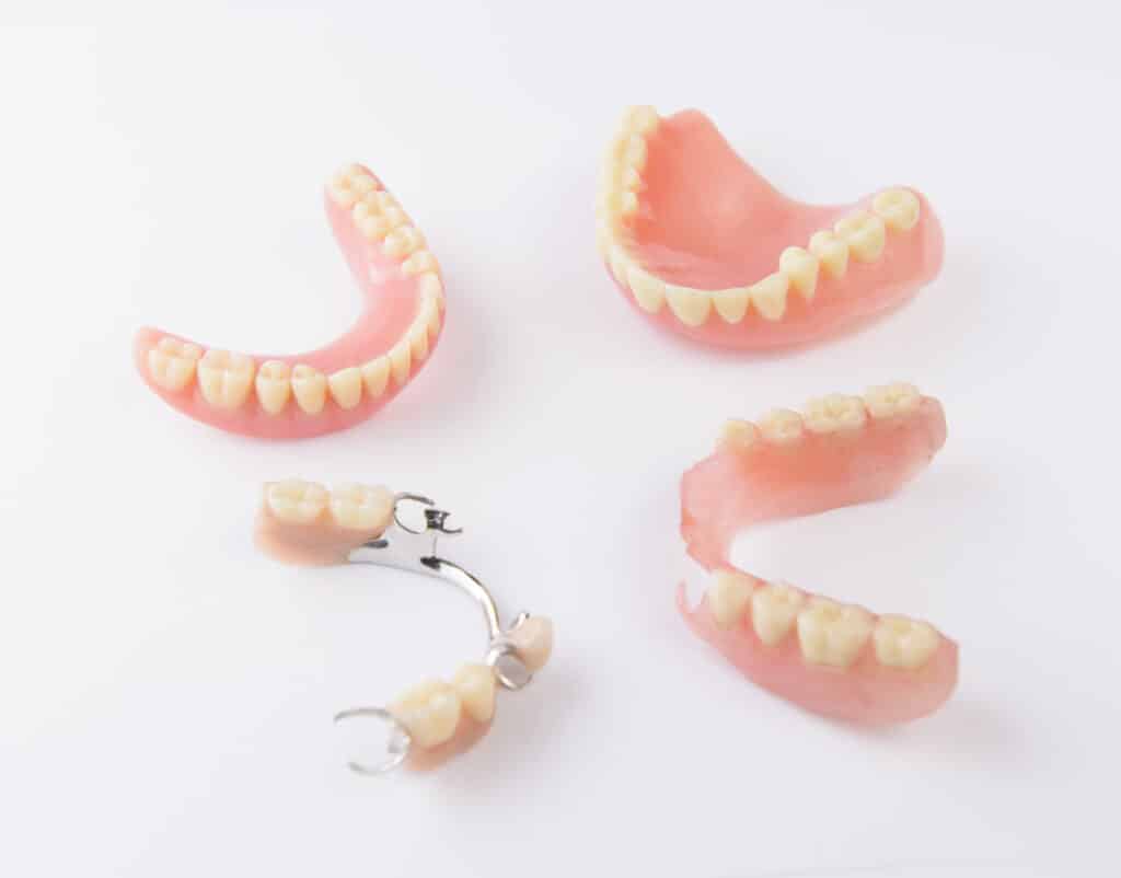 Group of dentures on white background.