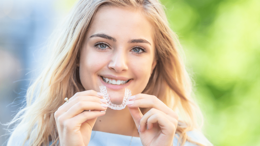 Young Woman holding Orthodontic Treatment